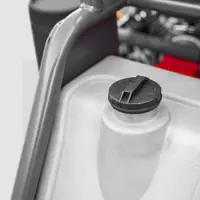 Water tank cap on a translucent tank between frame tubes