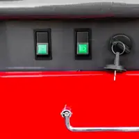 Two green light switches and a keyed ignition switch on the trowel panel
