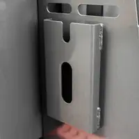 Steel bracket with a slotted opening on the frame beside the engine guard