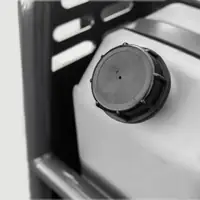 Black tank cap in a grey housing shielded by the frame